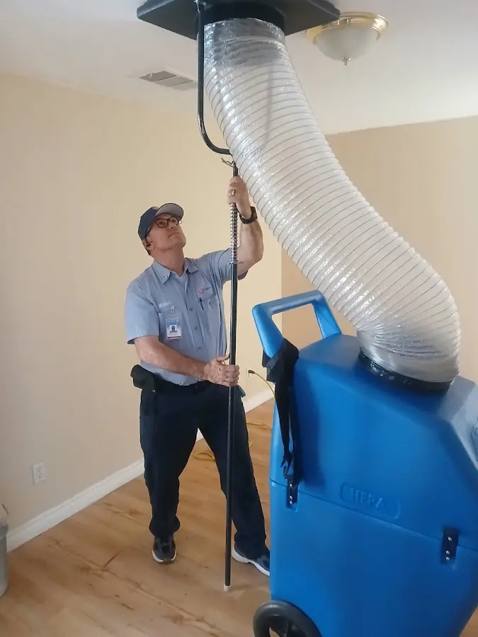 Furnace Tune-Up technician using HEPA equipment in South Apopka